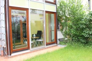 a sliding glass door of a house with a table in a yard at Casa Feliz in Bremen