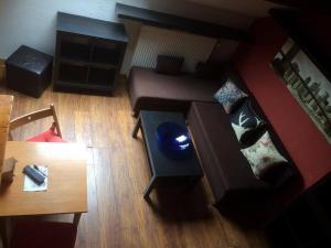a living room with a couch and a table at Appart-hôtel Maison de la Lune - petite Auberge d'Etterbeek in Brussels