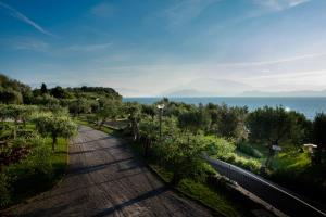 a road with a view of the ocean at Hotel Mon Repos in Sirmione