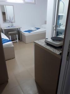 a bathroom with two beds and a sink at Apartments and Villas Janev in Star Dojran +143 photos