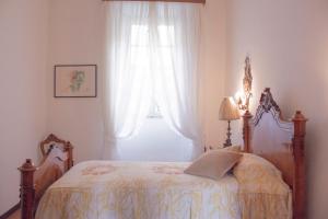 Ένα ή περισσότερα κρεβάτια σε δωμάτιο στο Villa Ruscone