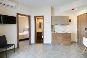 a room with a kitchen and a bedroom at Athens Comfort in Athens