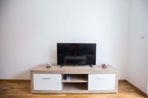 a wooden entertainment center with a flat screen tv on it at Jelena Apartment in Doboj