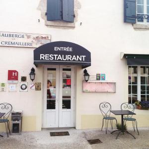 a restaurant with a table and chairs outside of it at Logis Auberge La Cremaillere in Villandraut