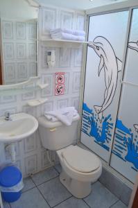 a bathroom with a toilet and a sink at Dolphin House in Puerto Baquerizo Moreno