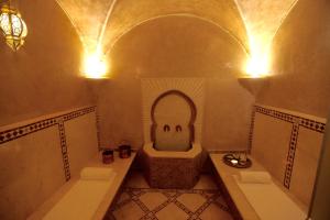 a bathroom with a tub and a toilet and a sink at Riad Dar Haven in Tamraght Ou Fella