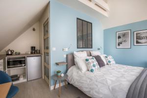 a bedroom with a white bed and a table at Chambre d'hôtes La Bourdonnaise in Bourdonné