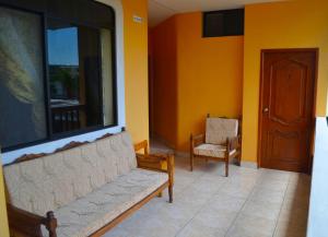 a living room with a couch and a chair at Dolphin House in Puerto Baquerizo Moreno