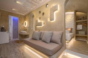a living room with a couch in a bedroom at Villa Adriana Hotel in Agios Prokopios