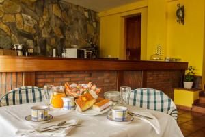 a table with a plate of food on it at Posada Mediavia in Ubiarco