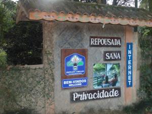 a building with signs on the side of it at Repousada Sana in Sana
