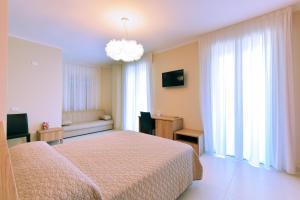 um quarto com uma cama e um lustre em Bed & Breakfast Sud em Gallipoli