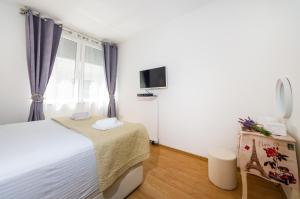 Postel nebo postele na pokoji v ubytování Apartman Lara