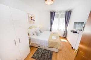 Postel nebo postele na pokoji v ubytování Apartman Lara