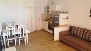 a living room with a couch and a kitchen at Apartments Sunny Punta in Privlaka
