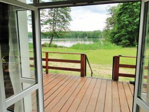 a screened porch with a view of a lake at Port przy Zeglarskiej in Ruciane-Nida