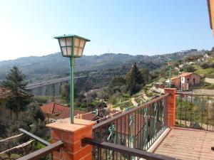 a lampost on a balcony with a view of a city at Albergo Jolanda in Diano Marina