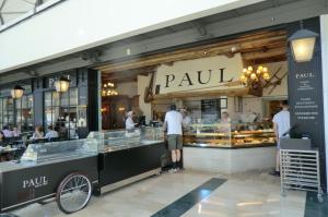 a group of people standing in front of a bakery at Natali'S Apartment in Serris +17 photos