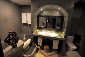 a bathroom with a sink and a mirror at Riad Dar Haven in Tamraght Ou Fella