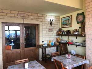 a room with a table and a counter with a clock at Sopra le Laure B&B in Laureana di Borrello
