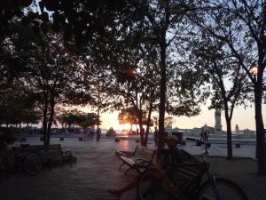 a person sitting on a bench in a park with a bike at Playa Los Cocos in Santa Marta