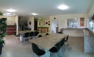 a dining room with a table and chairs in a room at Pousada Casagrande - Roma in Volta Redonda