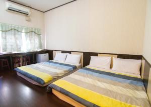 Postel nebo postele na pokoji v ubytování Luyi Ludao B&B