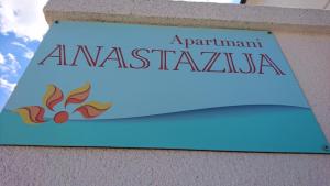 a sign on the side of a building at Apartments Anastazija in Pag