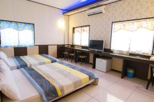 Postel nebo postele na pokoji v ubytování Luyi Ludao B&B