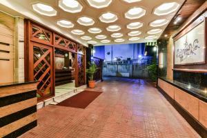 a large room with a ceiling with lights at Hotel Metro Palace in Mumbai