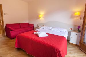 Postel nebo postele na pokoji v ubytování Hotel Le Rotonde