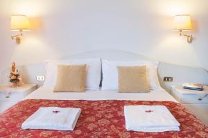Postel nebo postele na pokoji v ubytování Hotel Le Rotonde