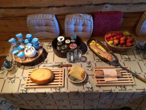 a table with bread and other foods on it at La Grange De L'Errance in Giron