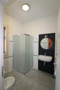 a bathroom with a sink and a toilet and a mirror at B&B Villa Bea in San Vito lo Capo +37 photos