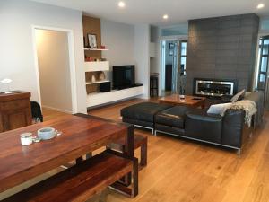 a living room with a couch and a table at Captains View in Kaiteriteri