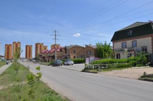 an empty street in a residential neighborhood with buildings at TAMYRLY Astana in Astana