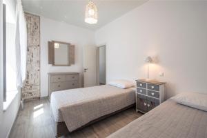 Posteľ alebo postele v izbe v ubytovaní Olive Tree House in Parikia