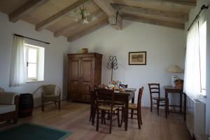 a dining room with a wooden table and chairs at Casali del Picchio - Winery in Cividale del Friuli