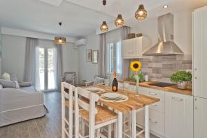 a kitchen and dining room with a table and chairs at Antikri villas in Kyra Panagia