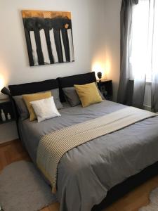 a bedroom with a large bed with pillows at Apartment Lungomare in Pula