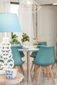 マラガにあるGR Suites Boutique Picassoのダイニングルーム(テーブル、椅子、ランプ付)