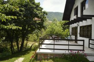 a balcony of a house with a table on it at Apartment Holiday - River view beside Pyramid in Visoko