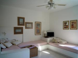 a living room with two beds and a tv at Palemilos Apartments in Elounda