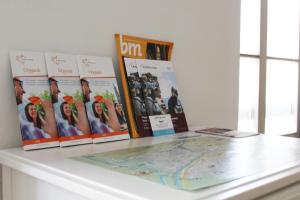 a counter with books and magazines on it at Lafri Apartment in Bolzano