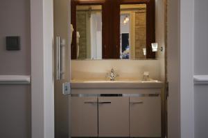 a bathroom with a sink and a mirror at Hotel Naumpasa Konagi in Istanbul