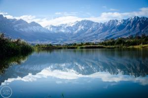 a view of a lake with mountains in the background at Reflections Guest Farm in Tulbagh