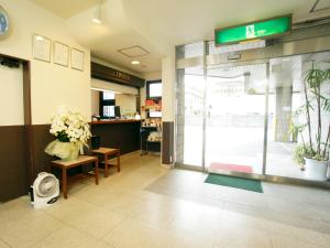 a lobby of a store with flowers on the door at Hotel Trend Saijo in Saijo