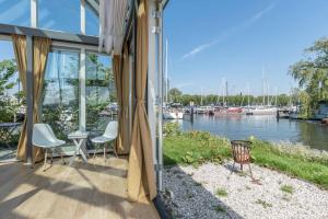 a house with a balcony with a view of a marina at The Panorama Suite (Mandelahuisje) in Amsterdam