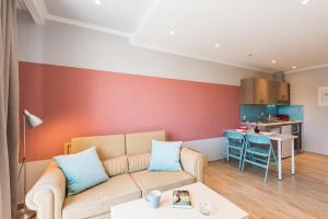 a living room with a couch and a kitchen at Pansion Ermioni in Skala