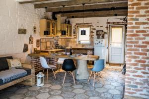 a kitchen with a table and chairs in a room at Rosemarino Country House in Chornomorsk